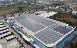 Large commercial building with expansive solar panel installation on the rooftop.