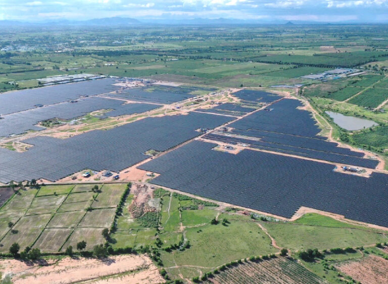 Aerial view of a large solar farm installation, showcasing extensive solar panel arrays.