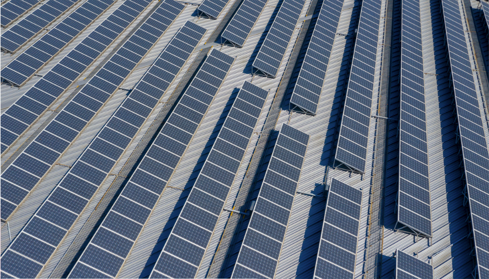 Aerial view of a large solar panel installation on a rooftop, likely for a green data center campus.