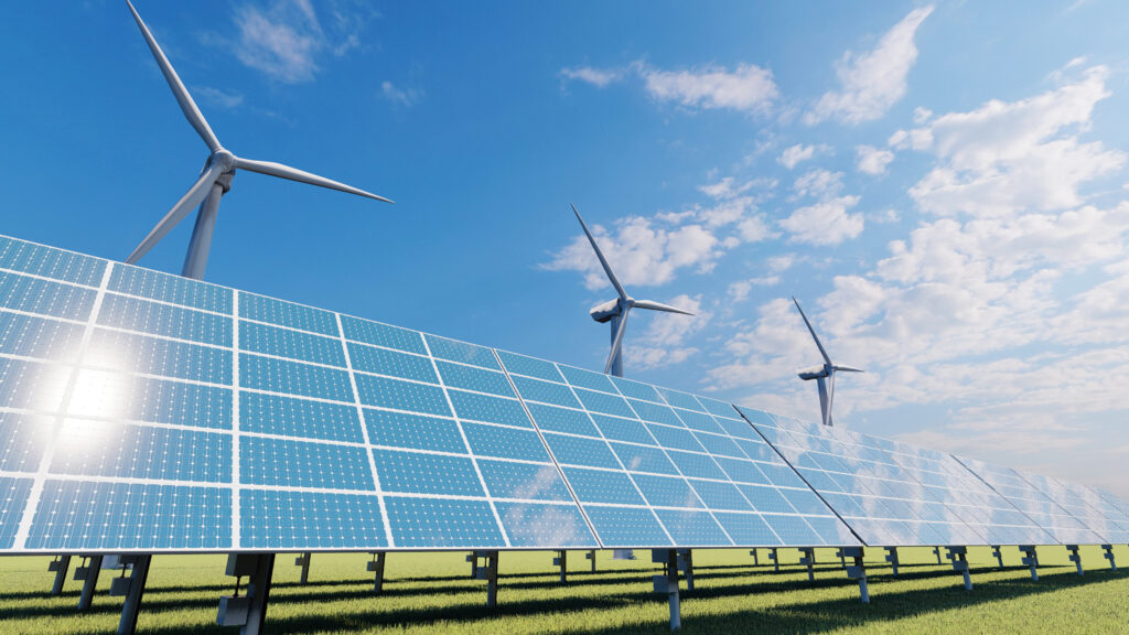Solar panels and wind turbines under a blue sky