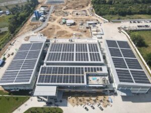Aerial view of Highlight Global Foods factory with extensive solar panel installation on rooftops.