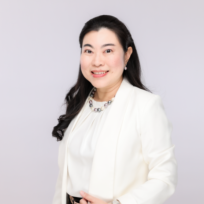 Thai woman in white blazer and pearl necklace, solar energy expert.