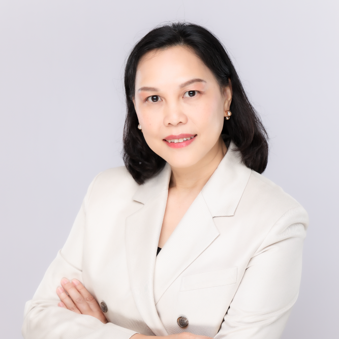 Professional woman in a cream blazer with arms crossed