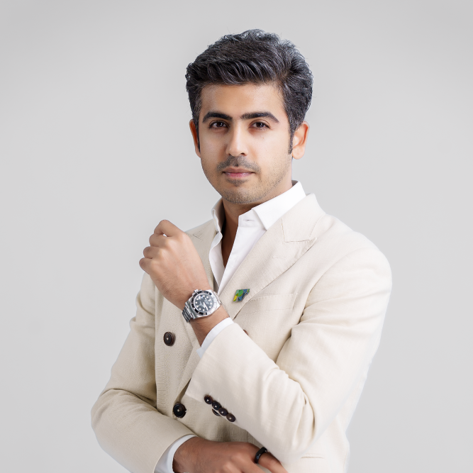 Man in a light suit with a watch and lapel pin