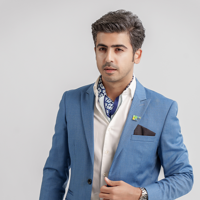 Man in blue suit with scarf and pocket square