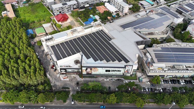 Aerial view of SB Design Square (CDC) with solar panels on the roof and surrounding greenery.