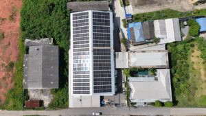 Aerial view of Sahachai Printing company's building with rooftop solar panels.